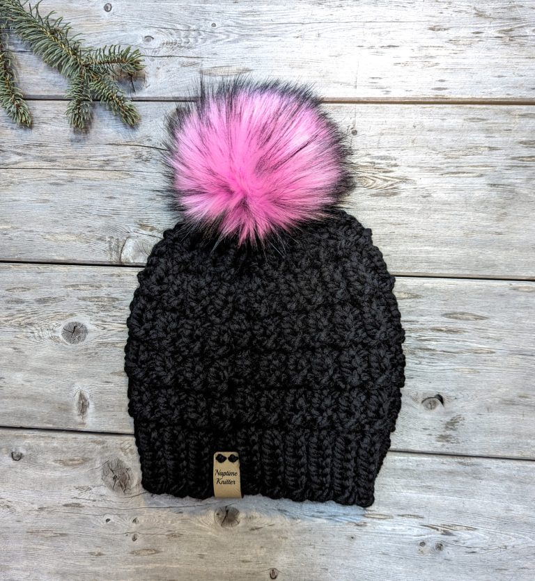 black hat with bubblegum pink faux fur pom pom